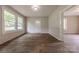 Bright living room with wood-look floors, wainscoting, and windows overlooking trees at 10 Bolt Dr, Shelby, NC 28150