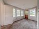 Bright, airy sunroom featuring wood-look flooring and an abundance of windows at 10 Bolt Dr, Shelby, NC 28150