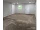 Unfinished basement with painted brick walls, concrete floor, and two doors at 1002 Hemlock Dr, Shelby, NC 28150