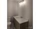 Well-lit bathroom featuring a modern vanity with stone countertop and a classic white toilet at 1002 Hemlock Dr, Shelby, NC 28150