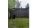 The back of a brick home featuring stairs to the basement door at 1002 Hemlock Dr, Shelby, NC 28150