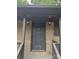 Home's gray front door, adorned with a classic knocker, is flanked by sconce lighting, enhancing curb appeal at 1002 Hemlock Dr, Shelby, NC 28150