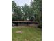 Charming brick home with a covered carport, lush lawn and mature trees, offering a serene setting at 1002 Hemlock Dr, Shelby, NC 28150