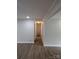 Hallway featuring wood floors with neutral-painted walls and trim, illuminated by recessed lighting at 1002 Hemlock Dr, Shelby, NC 28150