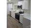 Modern kitchen with white cabinets, stainless steel appliances, and quartz countertops, perfect for cooking and entertaining at 1002 Hemlock Dr, Shelby, NC 28150