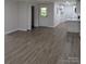 Open-concept living area with new hardwood floors leading to kitchen and bedrooms at 1002 Hemlock Dr, Shelby, NC 28150