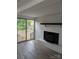 Living room with a brick fireplace, sliding glass doors, and hardwood flooring at 1002 Hemlock Dr, Shelby, NC 28150