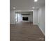 Bright living area showcasing hardwood floors and a fireplace with brick surround at 1002 Hemlock Dr, Shelby, NC 28150