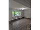 Bright living room featuring new flooring and a large window, offering ample natural light and a view at 1002 Hemlock Dr, Shelby, NC 28150