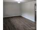 Spacious living room with new flooring, contemporary lighting, and fresh paint, ready for personal touches at 1002 Hemlock Dr, Shelby, NC 28150