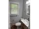 A well-lit bathroom featuring tile floors, gray walls and an updated vanity at 1101 Mona Dr, Charlotte, NC 28206