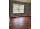 This bedroom features ample light, vinyl floors and a neutral gray paint at 1101 Mona Dr, Charlotte, NC 28206