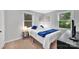 Comfortable bedroom featuring plush carpet, two bright windows, and neutral wall color at 1101 Mona Dr, Charlotte, NC 28206
