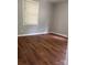 Cozy bedroom with new vinyl floors, a large window and neutral gray paint at 1101 Mona Dr, Charlotte, NC 28206