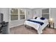 Bedroom featuring plush carpet, two bright windows, and neutral wall color at 1101 Mona Dr, Charlotte, NC 28206