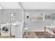Open-concept dining area featuring laundry, bar seating, and easy access to other rooms at 1101 Mona Dr, Charlotte, NC 28206