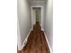 Long hallway featuring new vinyl floors and neutral gray paint at 1101 Mona Dr, Charlotte, NC 28206