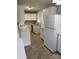 A functional kitchen featuring white cabinets, a white refrigerator and neutral countertops at 1101 Mona Dr, Charlotte, NC 28206