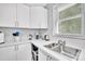 Modern kitchen with stainless steel sink, white countertops, and ample storage cabinets at 1101 Mona Dr, Charlotte, NC 28206