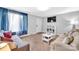 Comfortable living room with sofas, shelving, and a large window with flowing curtains at 1101 Mona Dr, Charlotte, NC 28206