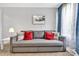 Cozy living room featuring modern sofa, natural light from a bright window, and neutral wall color at 1101 Mona Dr, Charlotte, NC 28206