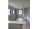 Bright living room featuring neutral walls, ceiling fan, and plenty of natural light at 1101 Mona Dr, Charlotte, NC 28206
