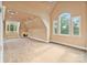 Spacious bonus room with vaulted ceilings, a fireplace and large windows providing natural light at 1118 Seminole Dr, Fort Mill, SC 29707