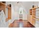 Bright closet featuring built in wooden shelves and hardwood floors at 1118 Seminole Dr, Fort Mill, SC 29707