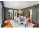 Elegant dining room featuring hardwood floors, decorative ceiling molding, and a stunning chandelier at 1118 Seminole Dr, Fort Mill, SC 29707