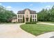 Charming two-story home featuring lush landscaping and a spacious driveway with manicured lawn in the front yard at 1118 Seminole Dr, Fort Mill, SC 29707