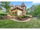 Exterior showcasing a three-car garage, stone accents, steps and manicured landscaping at 1118 Seminole Dr, Fort Mill, SC 29707