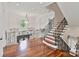 Bright foyer boasts hardwood floors, wrought iron railing, and elegant staircase at 1118 Seminole Dr, Fort Mill, SC 29707