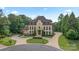 Stately home with circular driveway, mature landscaping, and custom architectural details at 1118 Seminole Dr, Fort Mill, SC 29707
