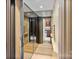 Hallway with mirrored walls and elevator access leading to the kitchen with wood cabinetry at 1118 Seminole Dr, Fort Mill, SC 29707