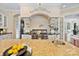 Close-up of a chef's kitchen showcasing a granite island with a sink and a professional cooktop at 1118 Seminole Dr, Fort Mill, SC 29707