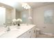 Bright bathroom featuring a double sink vanity with granite counters, large mirror and modern fixtures at 1119 Bellshill Dv, Indian Trail, NC 28079