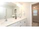 Bright bathroom with a double sink vanity, large mirror, flowers, and lots of light at 1119 Bellshill Dv, Indian Trail, NC 28079