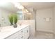 Bathroom featuring double sink, quartz counters, framed mirror, decorative vase and walk in shower at 1119 Bellshill Dv, Indian Trail, NC 28079