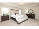 This bedroom has neutral walls, carpet floors, a tray ceiling, and a large window for natural light at 1119 Bellshill Dv, Indian Trail, NC 28079