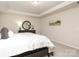A bedroom featuring neutral walls, carpet floors, a tray ceiling, and updated furnishings at 1119 Bellshill Dv, Indian Trail, NC 28079