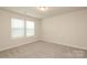 This bedroom has neutral walls, carpet floors, and a large window for natural light at 1119 Bellshill Dv, Indian Trail, NC 28079