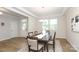 Spacious dining area features a stylish table set under a modern light, leading to a welcoming entryway at 1119 Bellshill Dv, Indian Trail, NC 28079