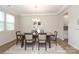 Elegant dining room with hardwood floors, chandelier, and view into the kitchen at 1119 Bellshill Dv, Indian Trail, NC 28079