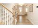Bright foyer with hardwood floors, staircase with carpet, and a white front door in the distance at 1119 Bellshill Dv, Indian Trail, NC 28079