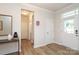 Bright foyer with hardwood floors and a white front door with glass panels at 1119 Bellshill Dv, Indian Trail, NC 28079