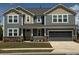 Charming two-story home with a covered front porch and a two-car garage, complete with a landscaped yard at 1119 Bellshill Dv, Indian Trail, NC 28079