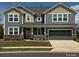 Charming two-story home with a covered front porch and a two-car garage, complete with a landscaped yard at 1119 Bellshill Dv, Indian Trail, NC 28079