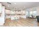Expansive kitchen with white cabinets, an island with bar seating, and a seamless view into the dining area at 1119 Bellshill Dv, Indian Trail, NC 28079