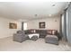 Comfortable basement living room with an oversized sectional and soft lighting, ideal for relaxation at 1119 Bellshill Dv, Indian Trail, NC 28079