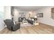 Cozy living room featuring hardwood floors, leather furniture, and a fireplace at 1119 Bellshill Dv, Indian Trail, NC 28079